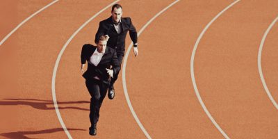 two men in a suit running